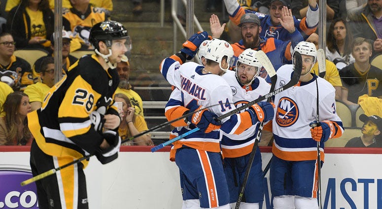 The Islanders' Brock Nelson (second from right) celebrates with teammates after scoring a goal in Game 4 of an Eastern Conference first-round playoff series against the Penguins on April 16, 2019, at PPG Paints Arena in Pittsburgh. 