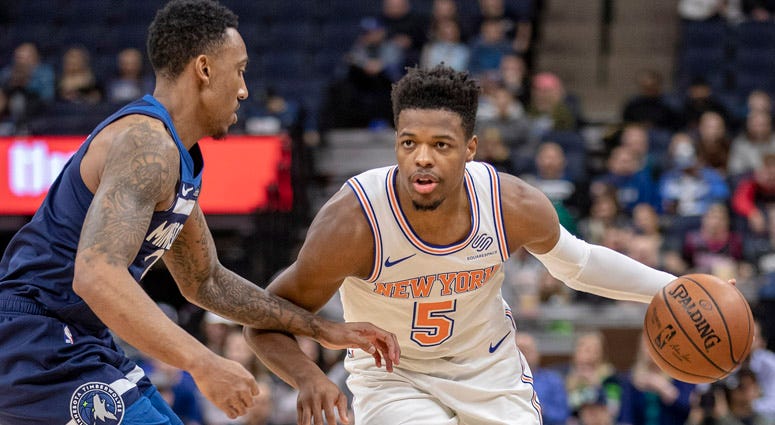 Knicks guard Dennis Smith Jr. dribbles the ball against Timberwolves guard Jeff Teague on March 10, 2018, at the Target Center in Minneapolis.