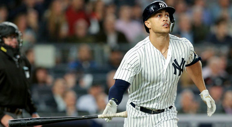 The Yankees' Giancarlo Stanton watches his solo home run against the Boston Red Sox during the fourth inning on May 8, 2018, at Yankee Stadium.