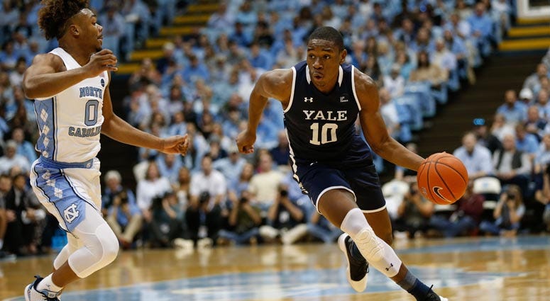 Yale guard Matthue Cotton drives against North Carolina Tar Heels guard Anthony Harris on Dec. 30, 2019, at Dean E. Smith Center in Chapel Hill, North Carolina.  
