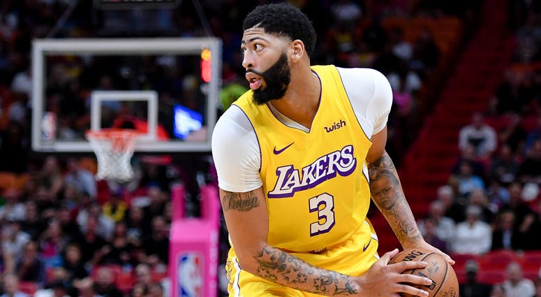 Lakers forward Anthony Davis is guarded by the Miami Heat on Dec. 13, 2019, at American Airlines Arena in Miami. 