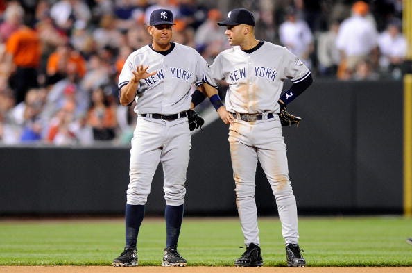 Alex Rodriguez and Derek Jeter chat during a 2009 Yankees game. 