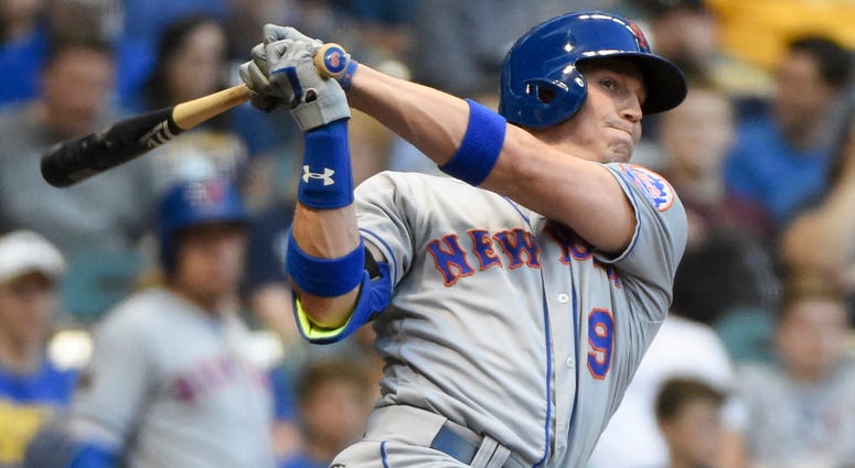 The Mets' Brandon Nimmo hits a triple against the Milwaukee Brewers on April 24, 2018, at Miller Park. 