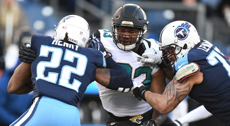 Titans running back Derrick Henry (22) is tackled for a loss by Jacksonville Jaguars defensive lineman Calais Campbell (93) on Dec. 31, 2017, at Nissan Stadium in Nashville.