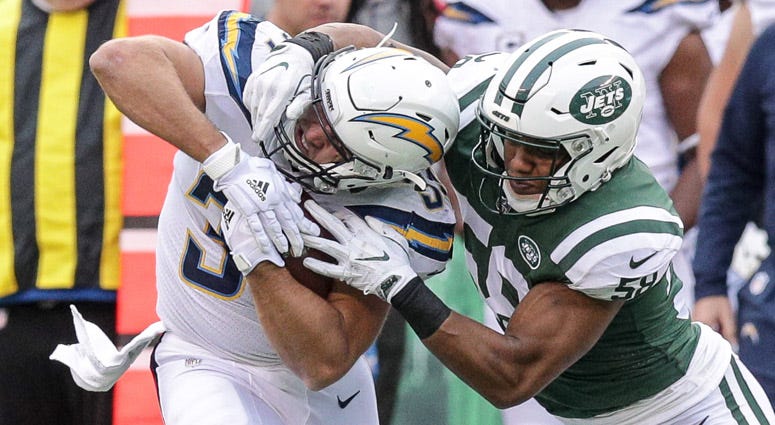 Chargers tight end Sean McGrath is tackled by Jets linebacker Darron Lee during on Dec. 24, 2017, at MetLife Stadium.