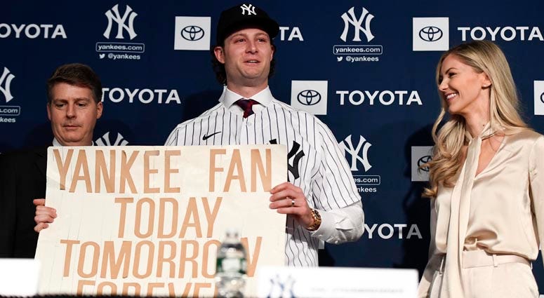  Yankees pitcher Gerrit Cole holds the sign he was photographed with at the 2001 World Series as a kid. Danielle Parhizkaran/USA TODAY Images