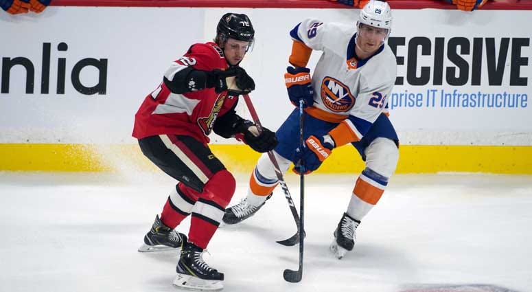Senators defenseman Thomas Chabot battles with Islanders center Brock Nelson in the third period on March 5, 2020, at the Canadian Tire Centre in Ottawa, Ontario.    