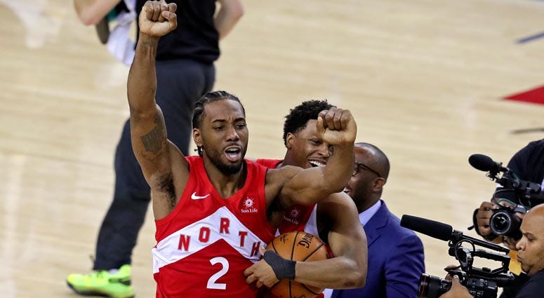 The Raptors' Kawhi Leonard (2) and Kyle Lowry celebrate winning the NBA championship over the Golden State Warriors after Game 6 of the NBA Finals on June 13, 2019, at Oracle Arena in Oakland, California. 