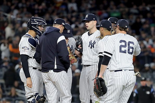 Aaron Boone talks with James Paxton on the mound during the ALCS. 