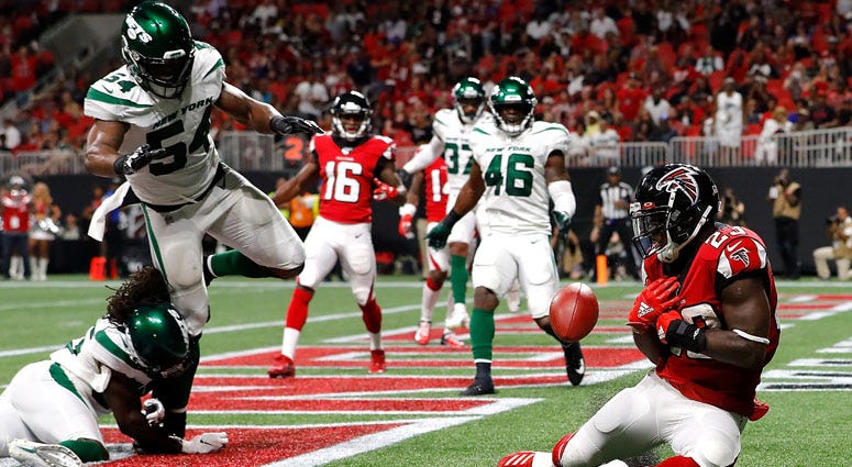 Brian Hill of the Atlanta Falcons fails to pull in this reception for a TD against Tevaughn Campbell and Avery Williamsonof the Jets on Aug. 15, 2019 in Atlanta.