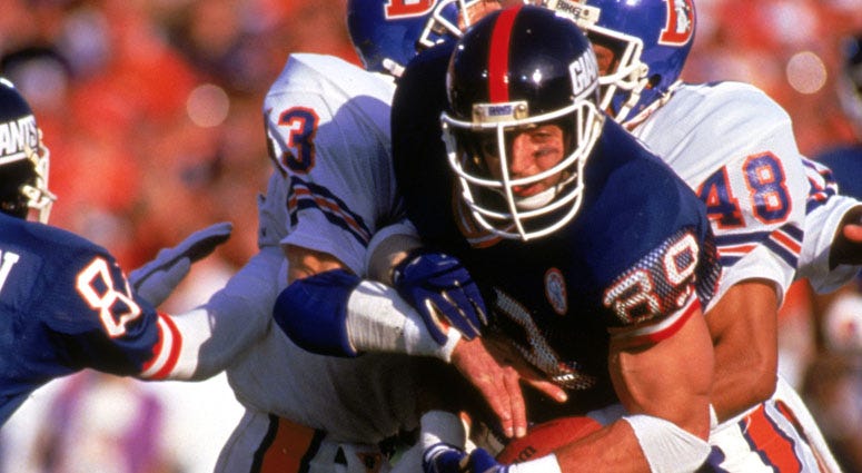 Giants tight end Mark Bavaro fights for yardage against the Denver Broncos during Super Bowl XXI.
