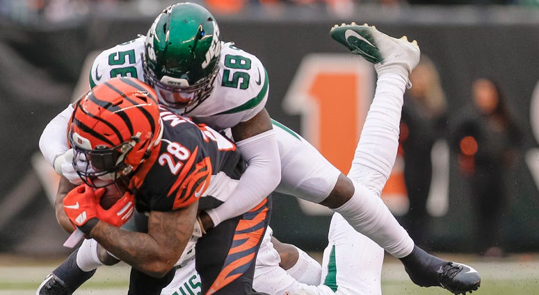 James Burgess of the Jets makes the tackle on Joe Mixon of the Cincinnati Bengals at Paul Brown Stadium on Dec. 1, 2019,  in Cincinnati, Ohio.