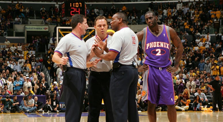 Los Angeles, CA - April 28, 2006: Tim Thomas of the Phoenix Suns looks in on as referees Tim Donaghy #21, Bill Spooner #22 and Eddie F. Rush discuss the proper call 