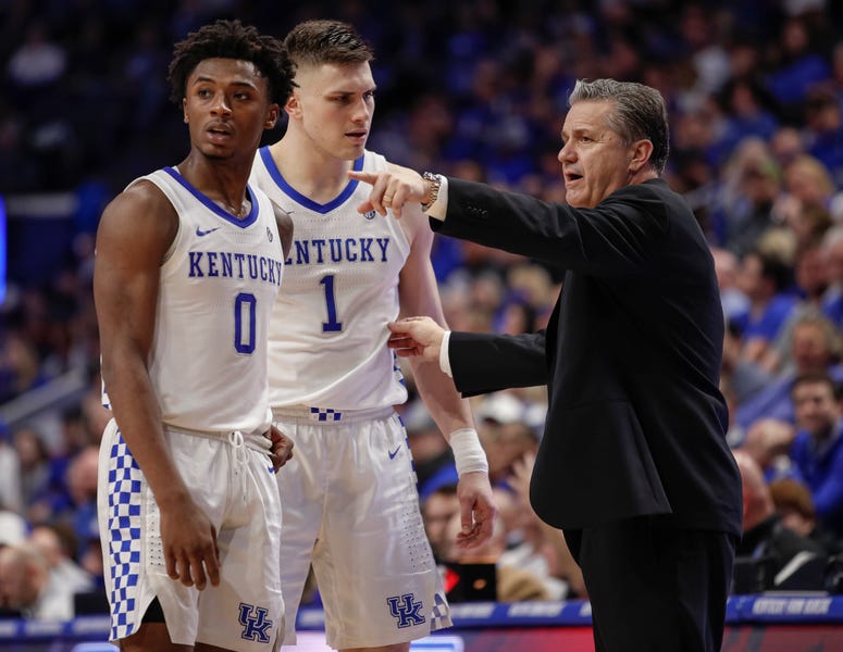 Ashton Hagans and Nate Sestina of the Kentucky Wildcats talk with head coach John Calipari of the during the second half against the Mississippi State Bulldogs at Rupp Arena on February 4, 2020 in Lexington, Kentucky.