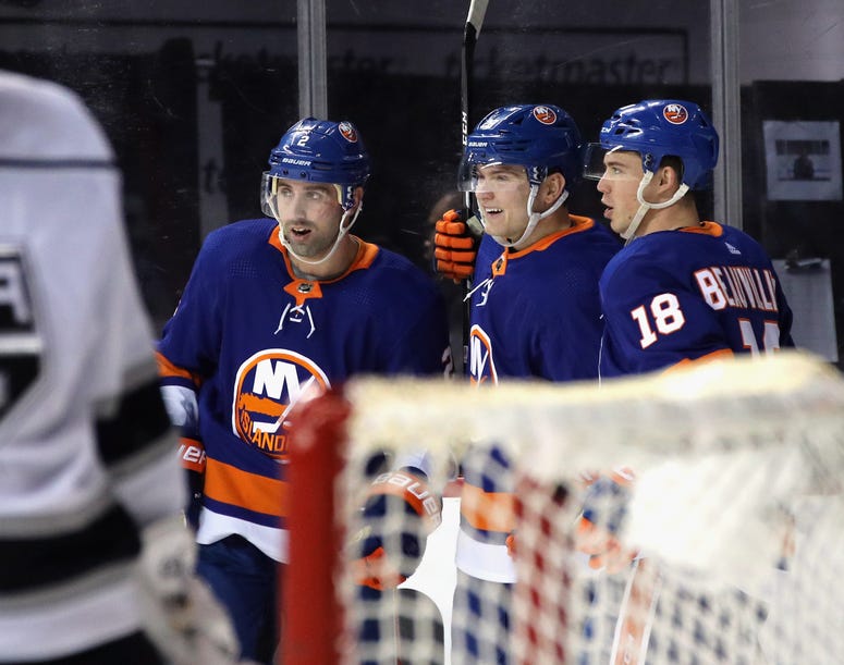 Kieffer Bellows of the Islanders celebrates his first NHL goal against the Los Angeles Kings at 10:22 of the second period and is joined by Nick Leddy and Anthony Beauvillier at the Barclays Center on February 06, 2020.