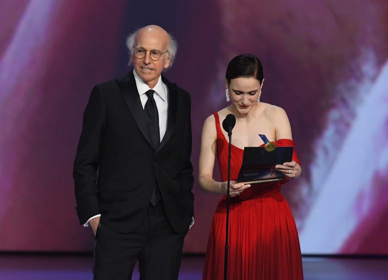 Larry David and Rachel Brosnahan speak onstage during the 70th Emmy Awards at Microsoft Theater on September 17, 2018 in Los Angeles, California.