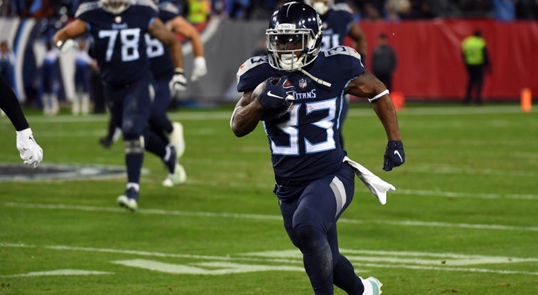 Tennessee Titans running back Dion Lewis (33) runs for a first down during the first half against the Jacksonville Jaguars at Nissan Stadium