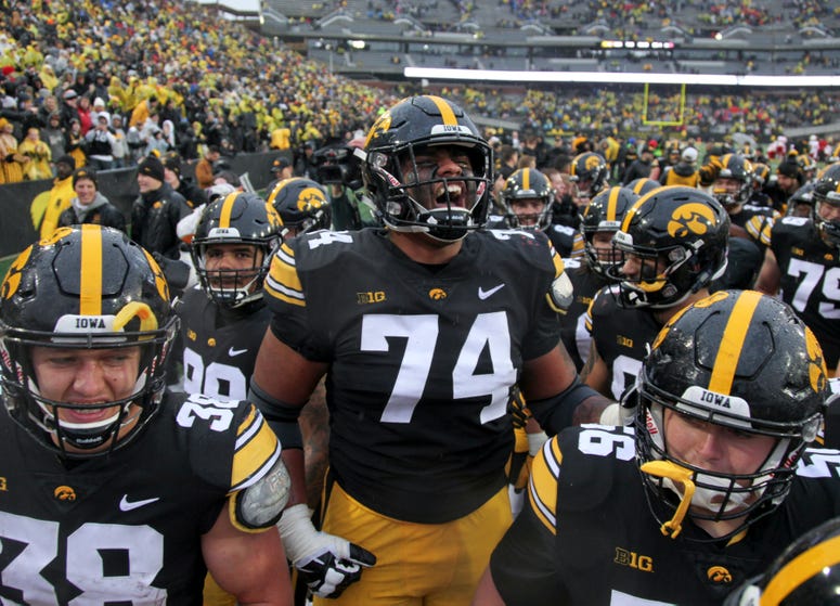 Offensive lineman Tristan Wirfs of the Iowa Hawkeyes celebrates with teammates after their match-up against the Nebraska Cornhuskers on November 23, 2018 at Kinnick Stadium, in Iowa City, Iowa.