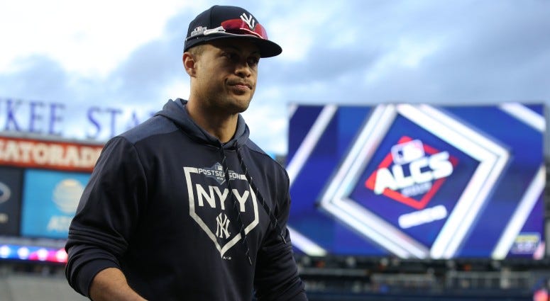 New York Yankees left fielder Giancarlo Stanton (27) walks off the field after fielding balls in the outfield during batting practice before game four of the 2019 ALCS playoff baseball series on Oct 17, 2019 against the Houston Astros.