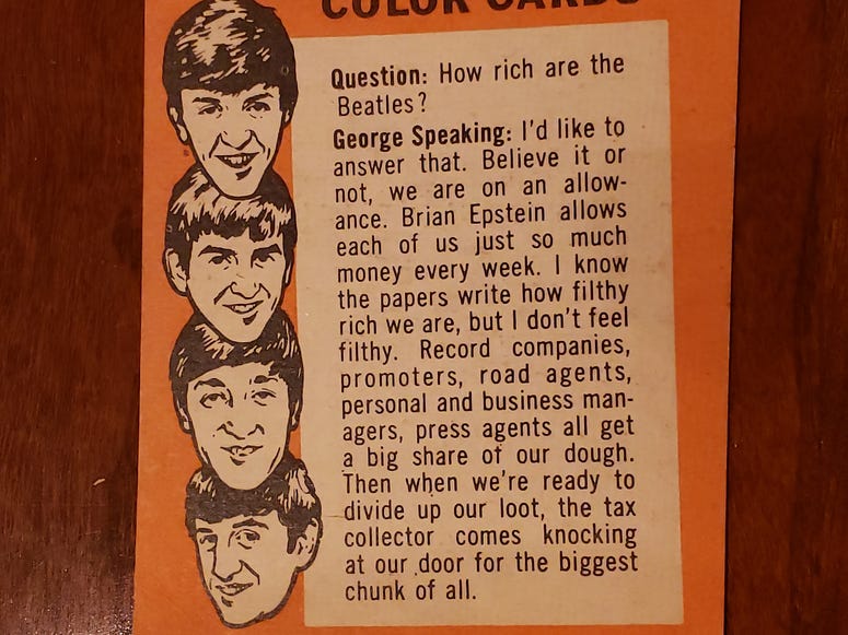 George Harrison takes a question on the back of this Beatles card.