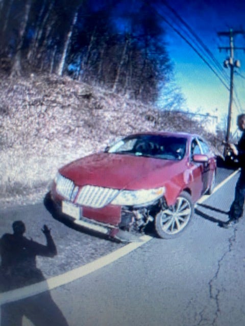 Red Lincoln Sedan with damage